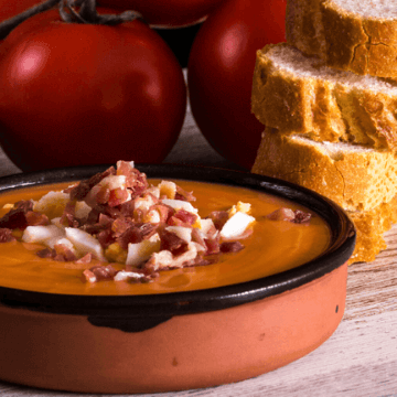 Tomato, bread and salmorejo during a meal in Spain