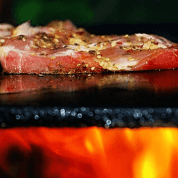 Meat being grilled in one of the Spanish Restaurants Barcelona | ForeverBarcelona