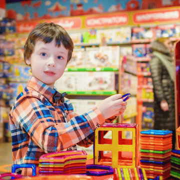 Kid playing with Spanish toys